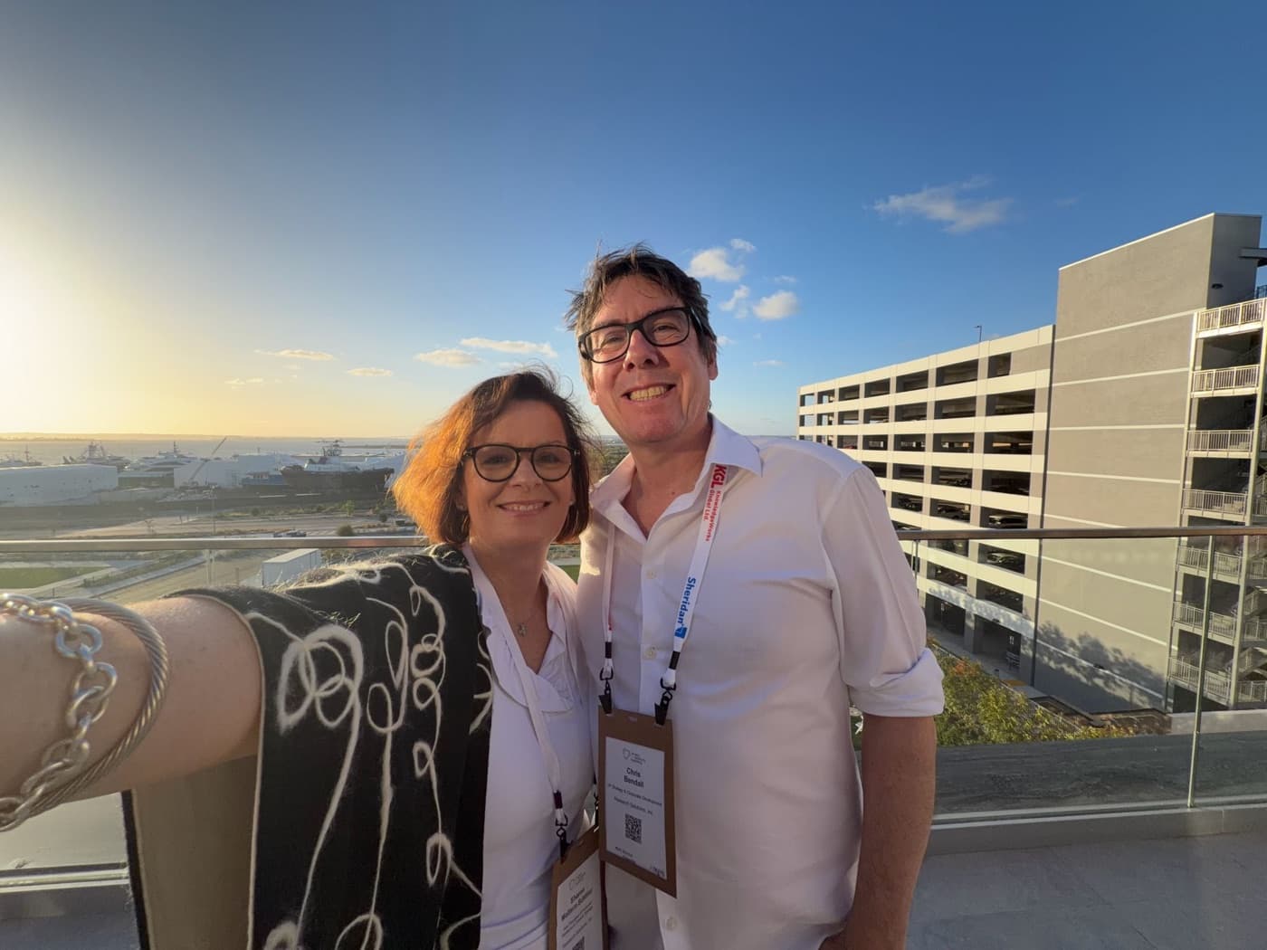 Two team members at a rooftop conference reception
