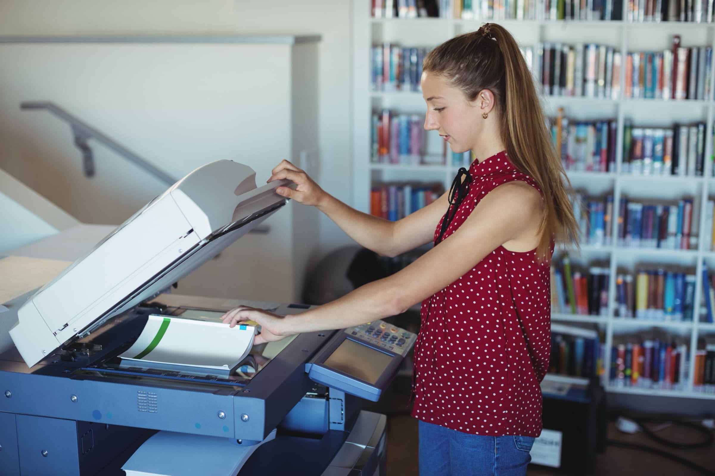 Librarian scanning a print document in a library for digital delivery